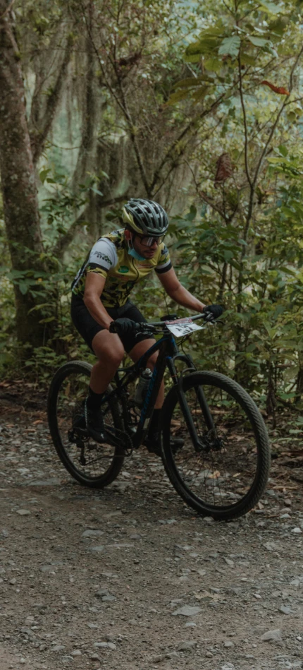 man riding a mountain bike in the woods