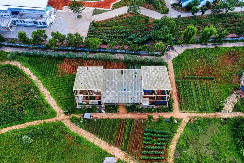 a house sitting in a field near a road