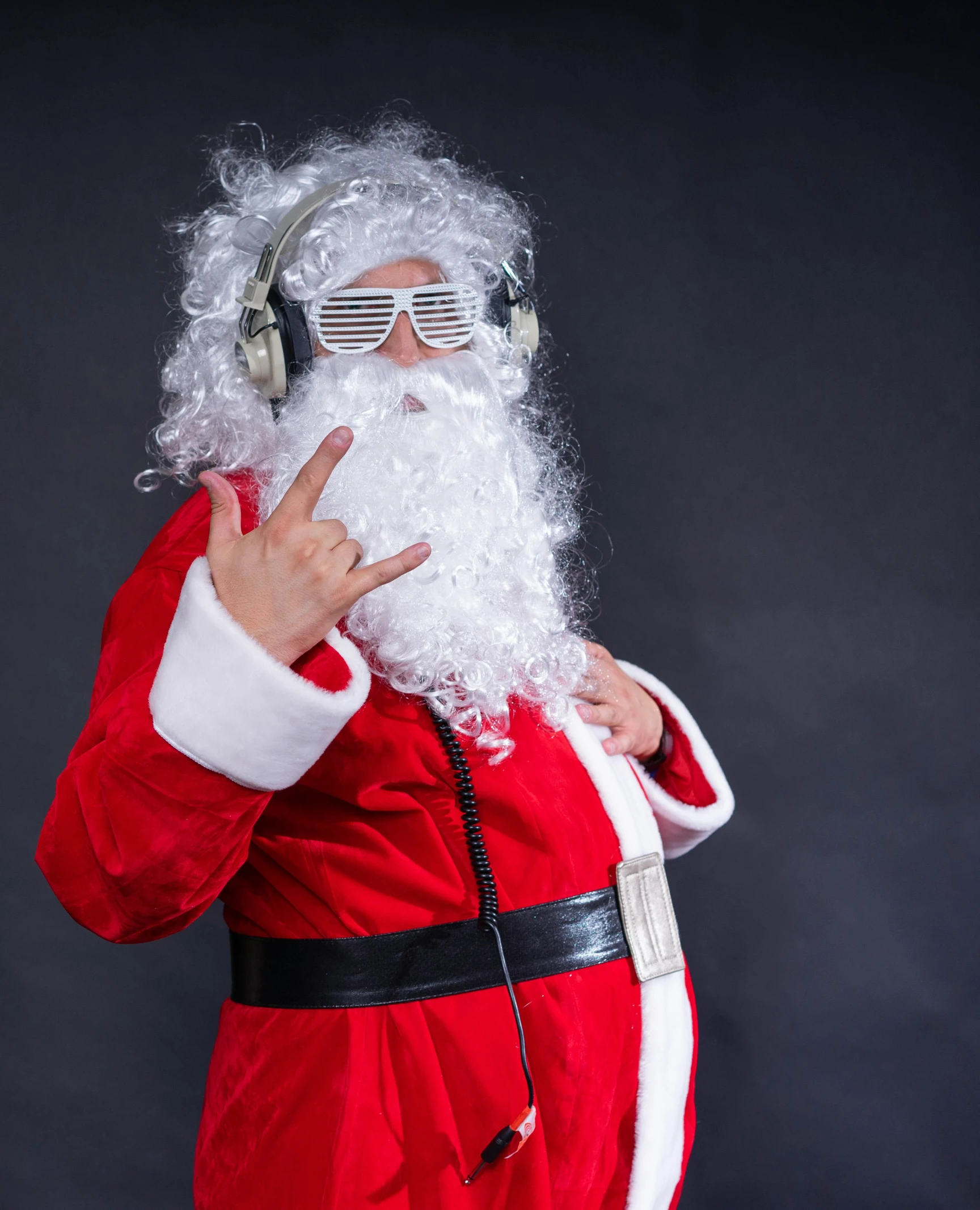 a santa clause with headphones on giving the finger sign