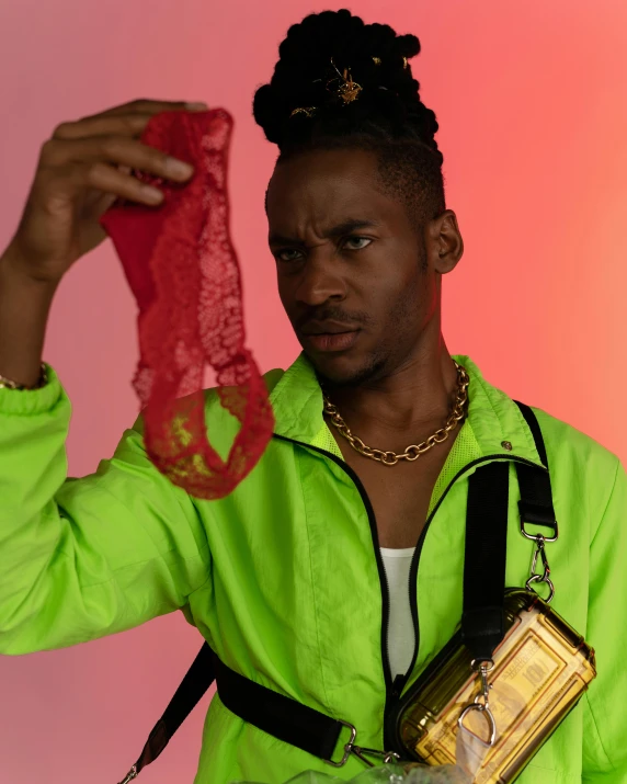 a woman in green shirt holding up a piece of fabric