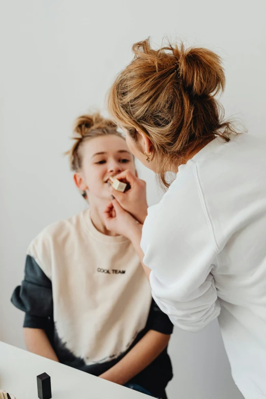 two women looking at each other laughing