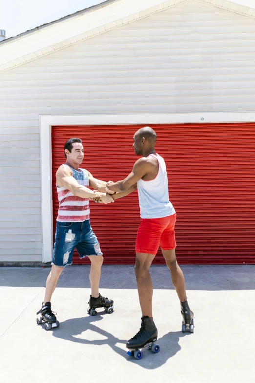 the two men are both on roller skates