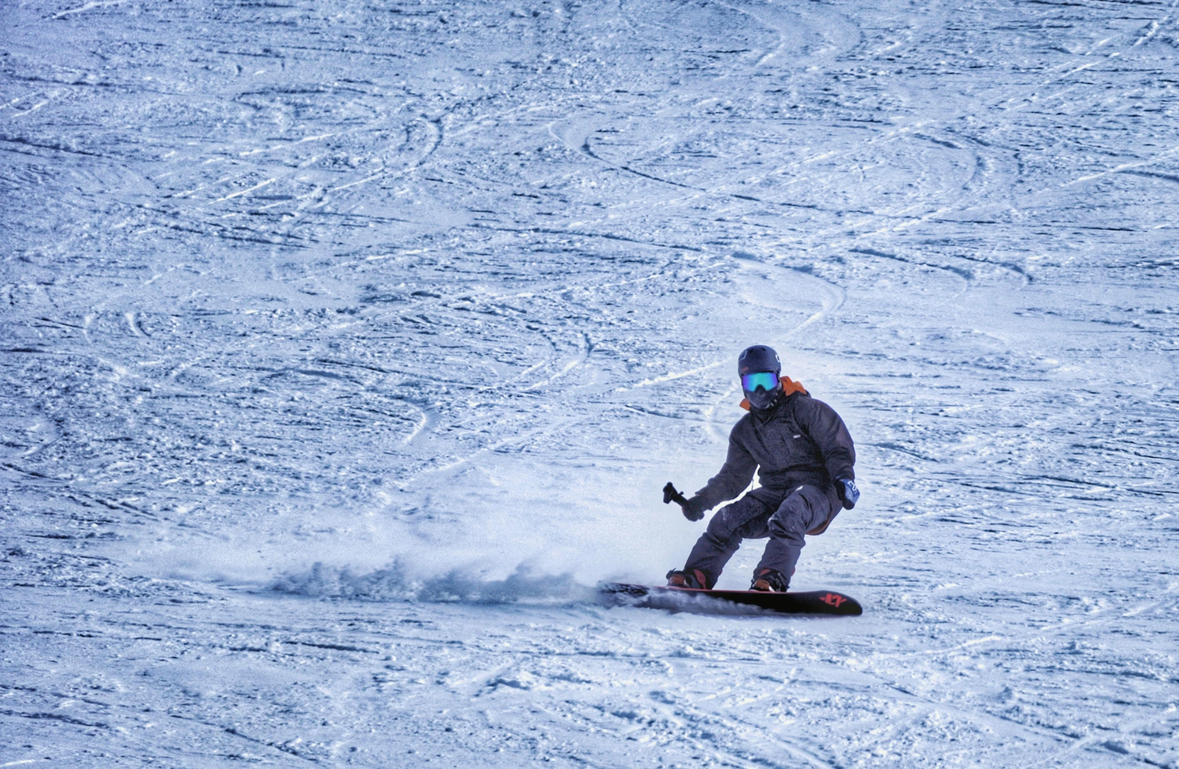 a skier makes a turn while going down a slope