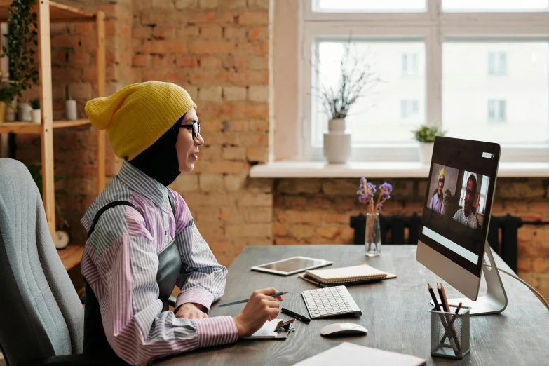 the woman is in the chair using the computer