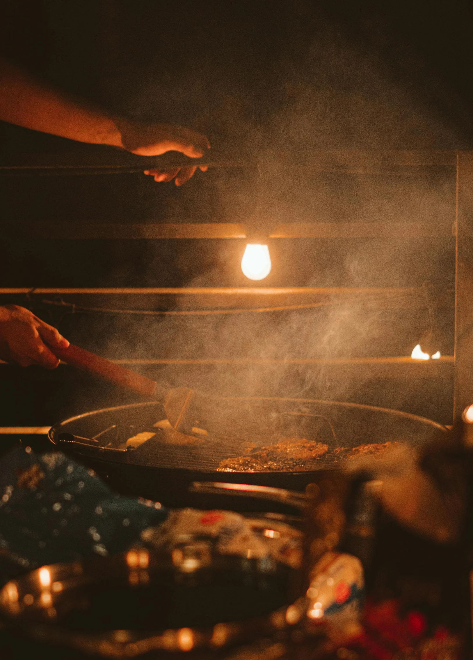 cooking on an outdoor grill in the night