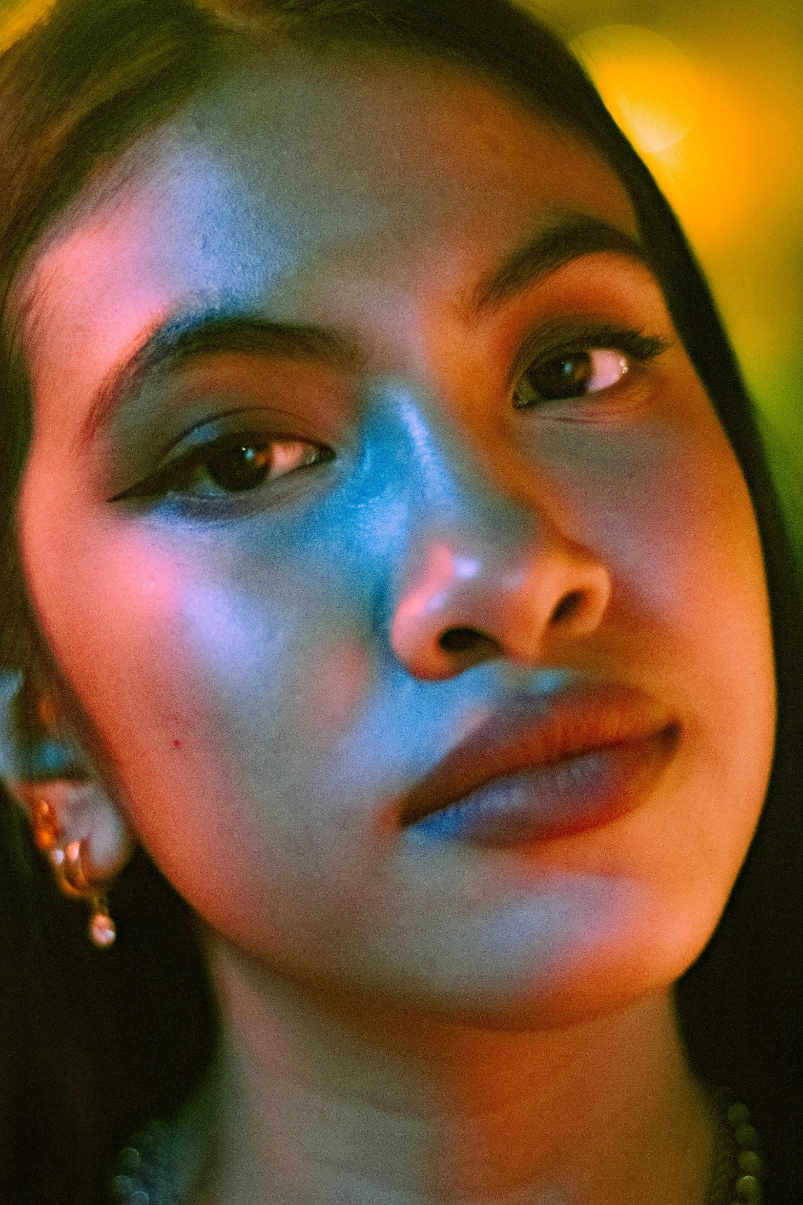 a girl in a dark background with bright lighting