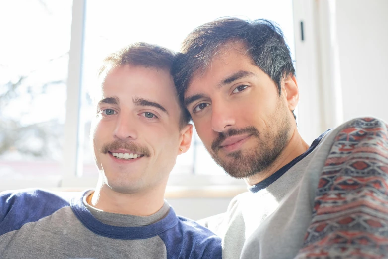 two young men are posing for a po