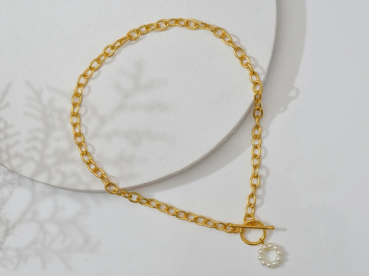 a pearl beaded celet with gold chain