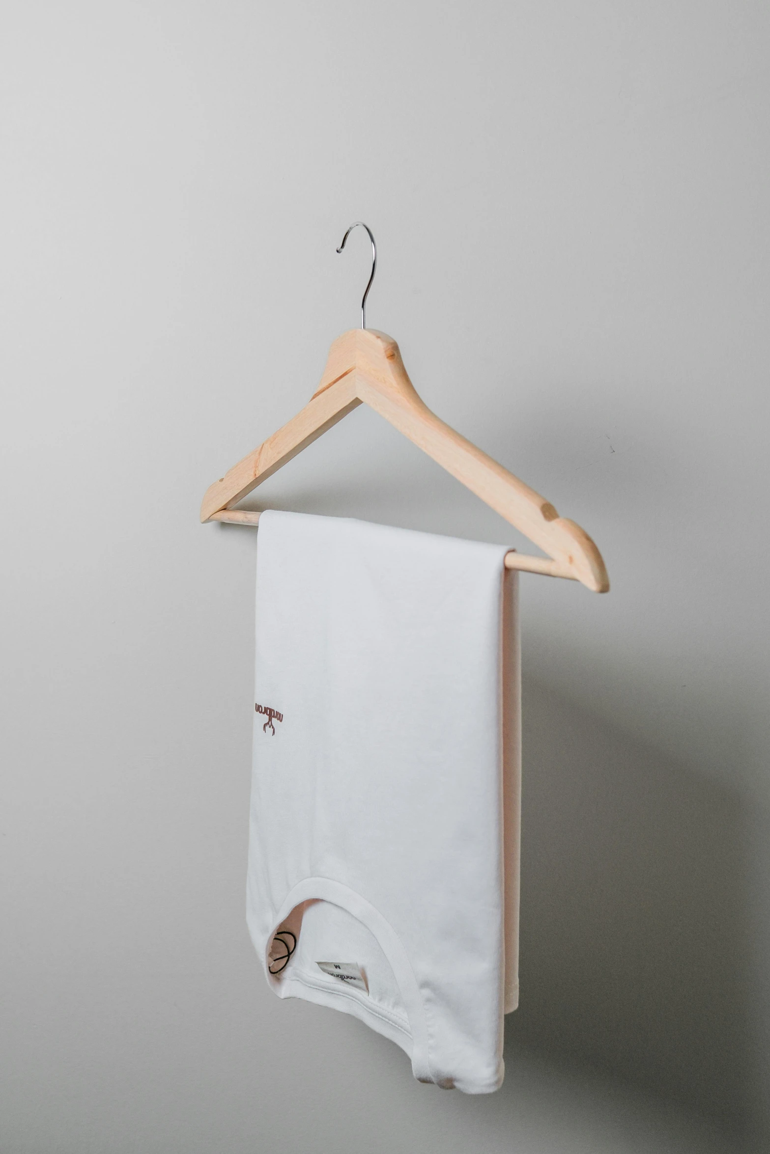 an organic baby towel hanging from a clothes rack