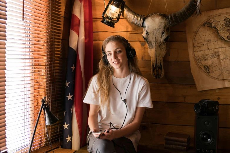 a woman wearing headphones sitting in a room