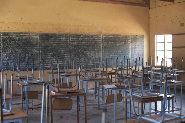 a classroom with a brick wall and writing board with no door