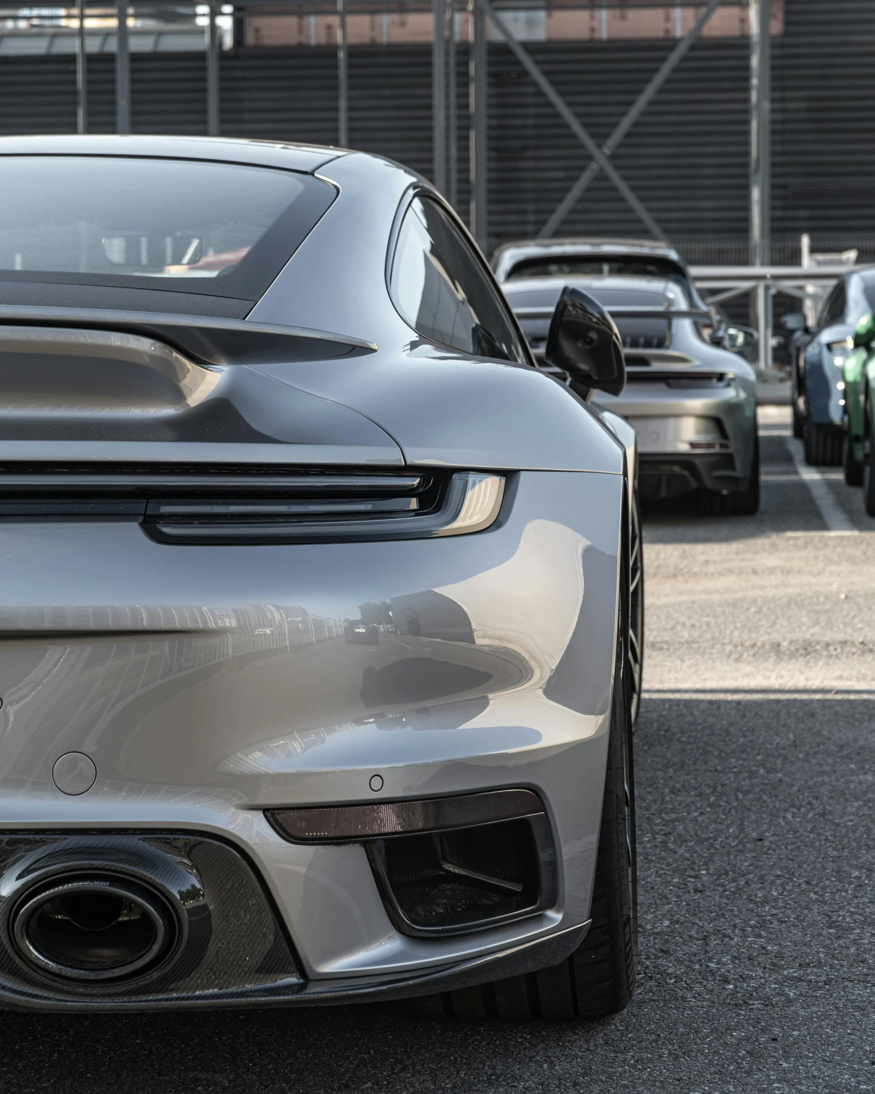 a close up of the tail end of a grey sports car