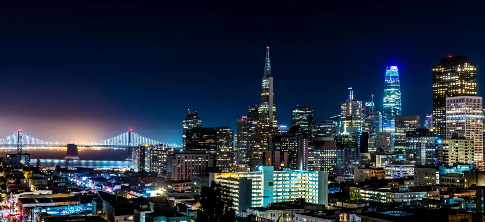 many tall buildings near one another and a bridge