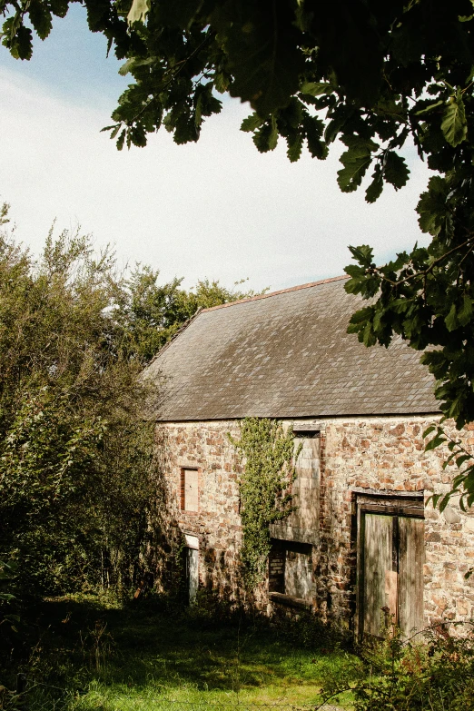 a very old stone building surrounded by some trees