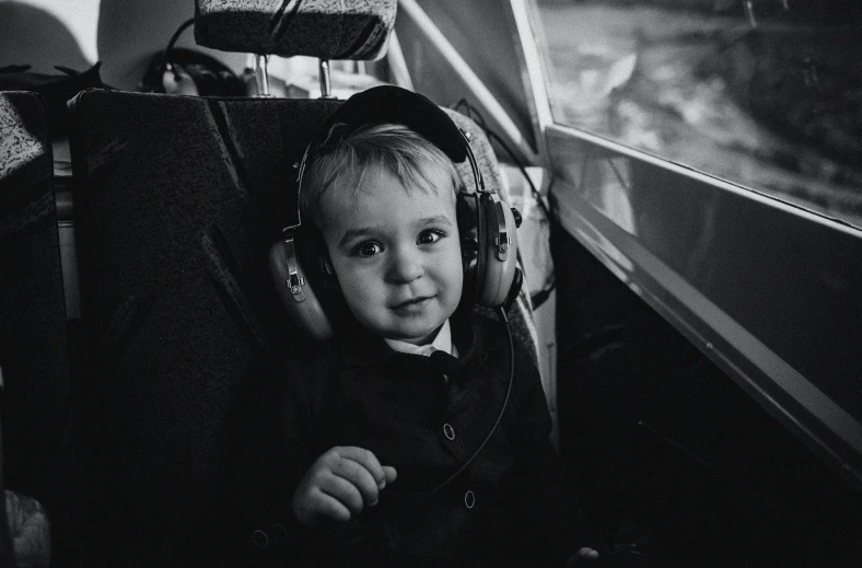 a little girl sitting in a suitcase with the handle closed