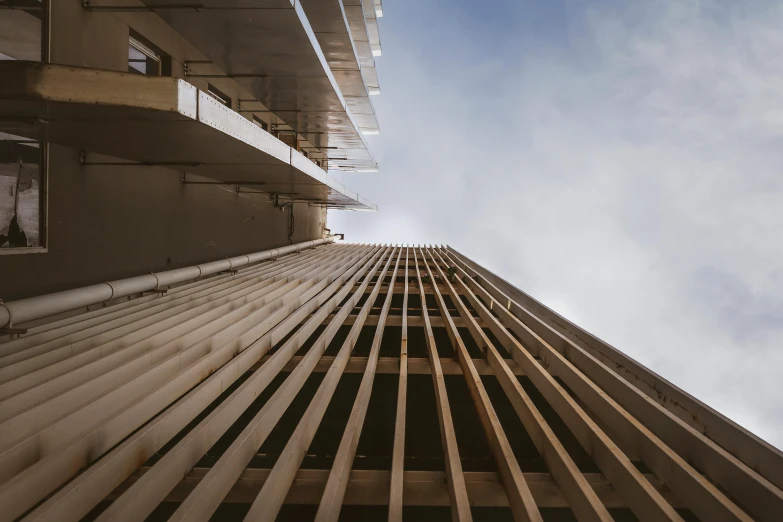 a high rise building with no windows under a blue sky