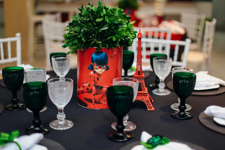 a table topped with vases and glasses on top of a table