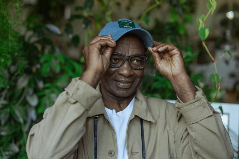 a man is wearing a cap and a jacket