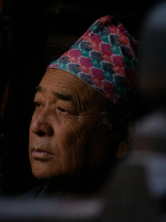 a man is wearing a colorful hat