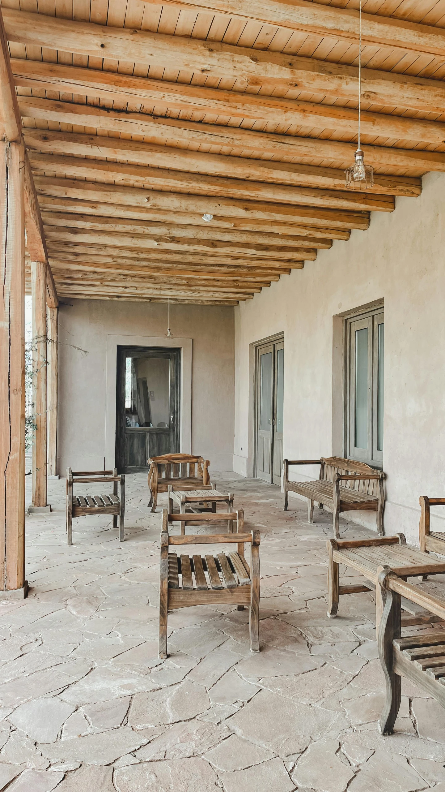 a group of chairs and benches in an enclosed area