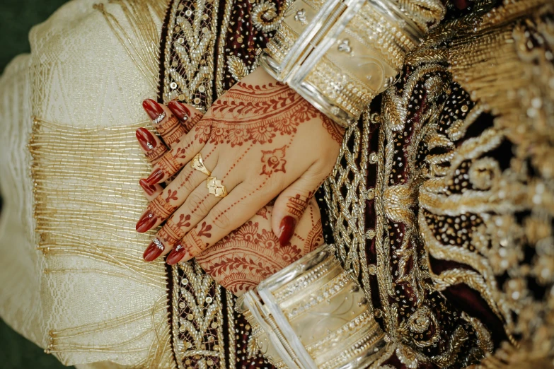 a bride with red nails holding onto her hands