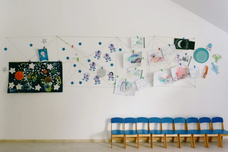 a group of chairs in a corner near an art work