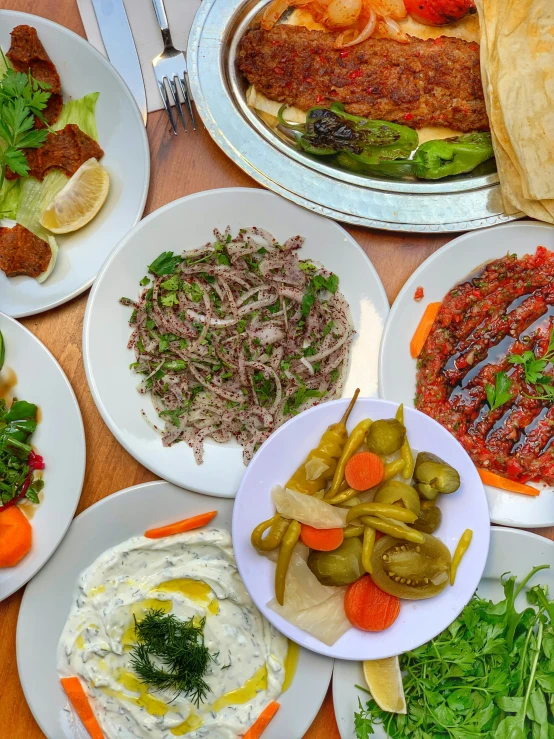 a wooden table topped with plates of food