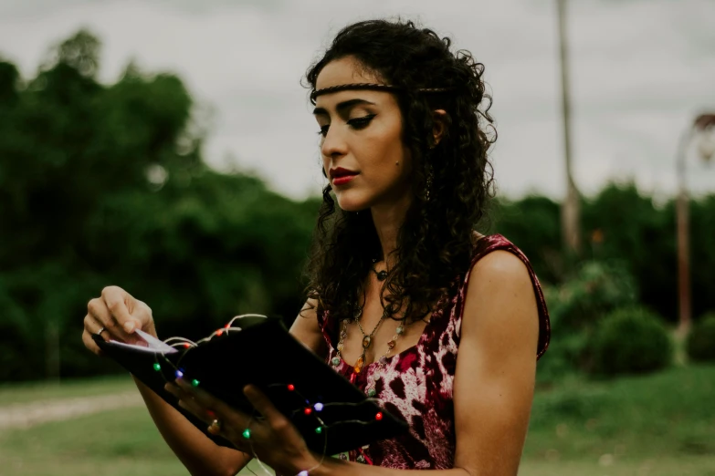 a woman in a dress is writing on a paper