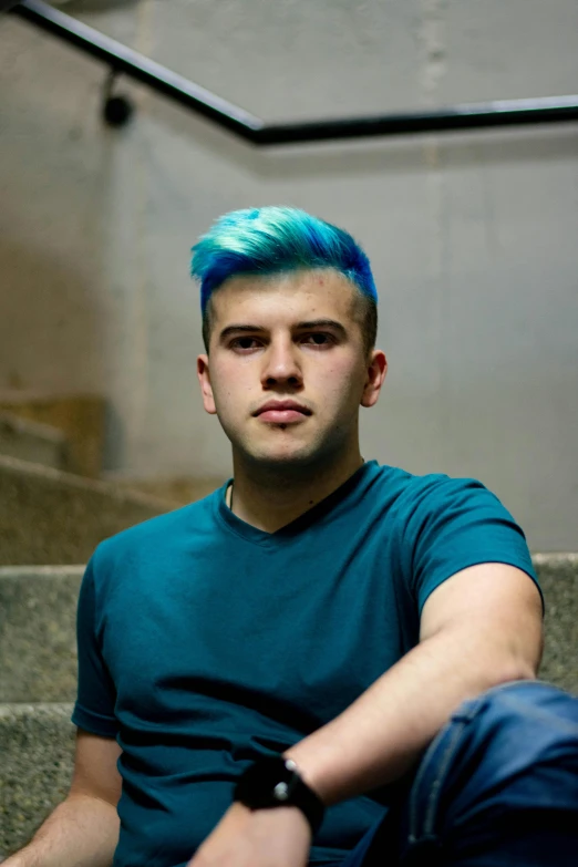 a boy with blue hair sitting on the steps