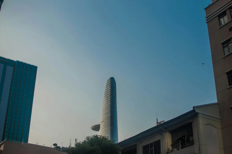 a tower towering in the sky next to a building