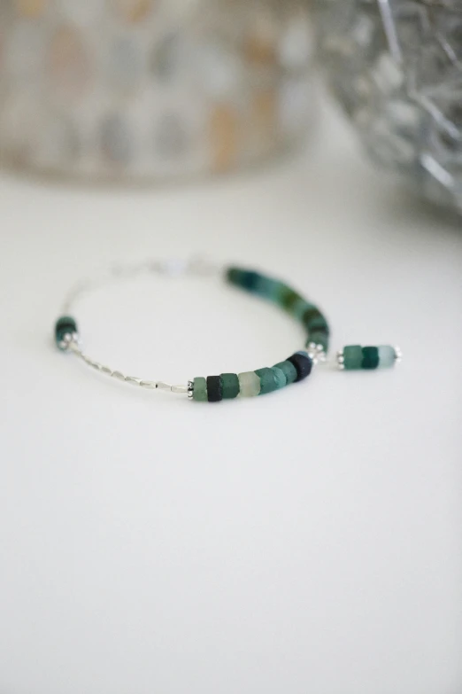 a green bead celet and glass bead beads