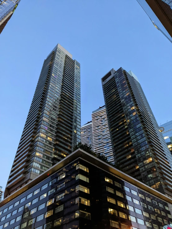 high rise buildings in a business district near the sun