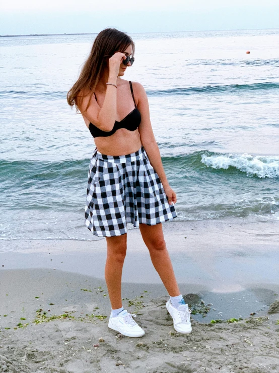 girl in a bikini standing on the beach