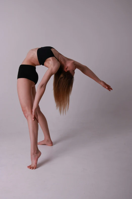 woman stretching with arms spread in front of white background