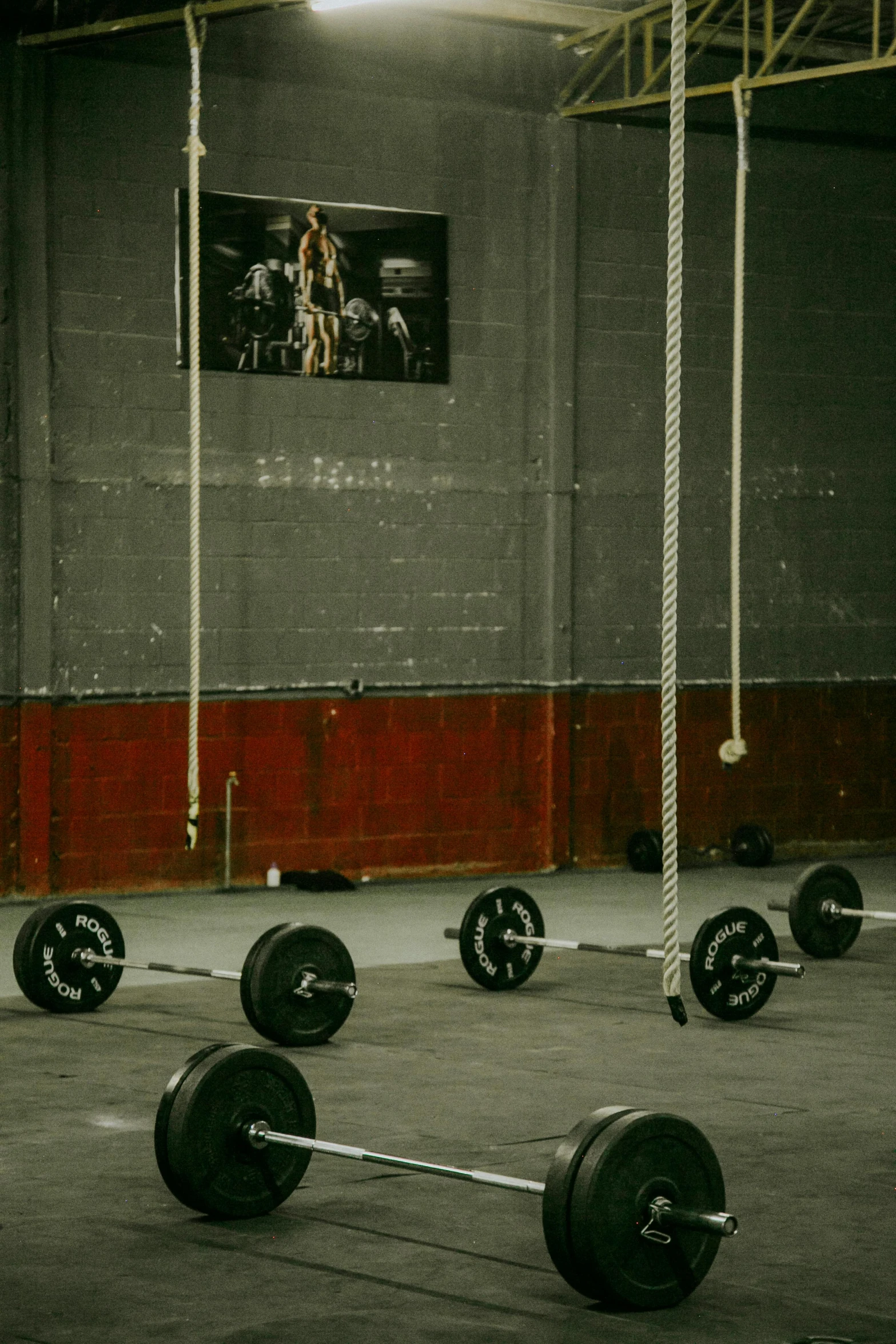 a man lifts heavy metal objects into a room