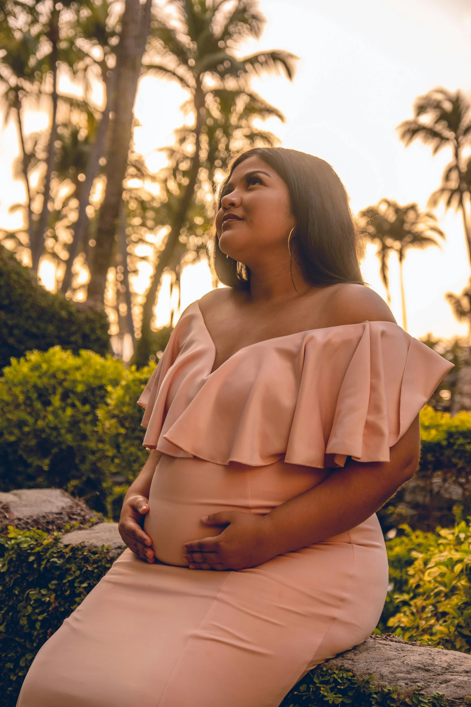 an attractive woman in pink poses for a picture