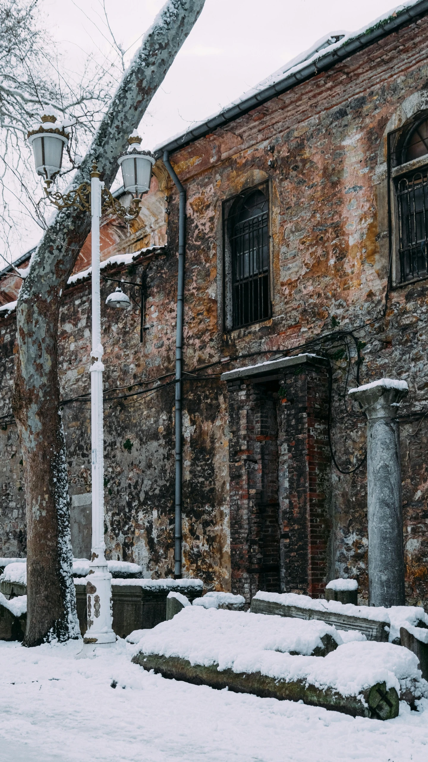 an old brick building is covered in snow