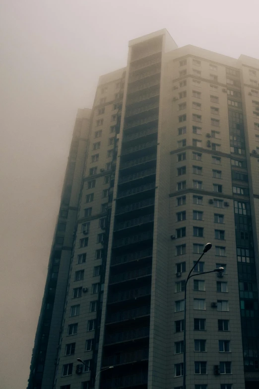 building near the road with street light, in the fog