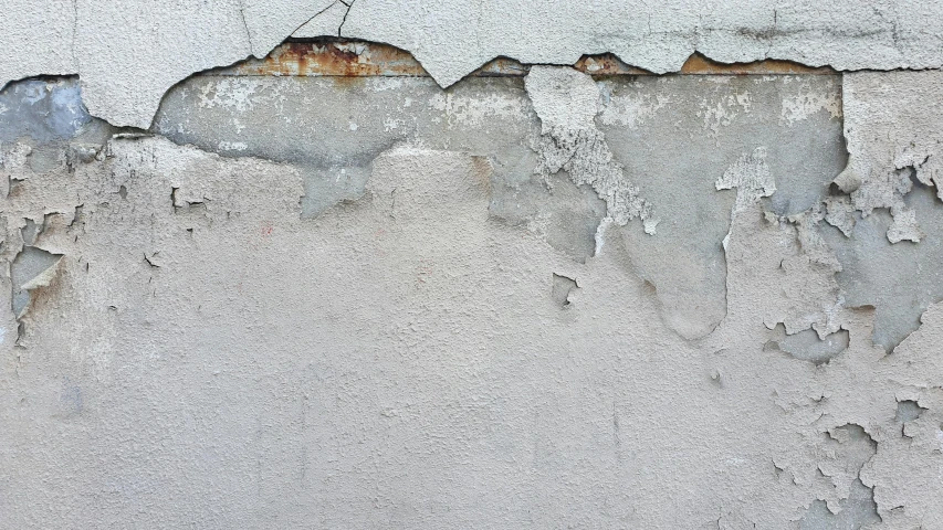 the paint is chipped off of the cement wall