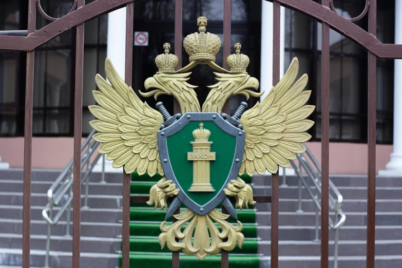 the entrance to a building with a green and gold gate