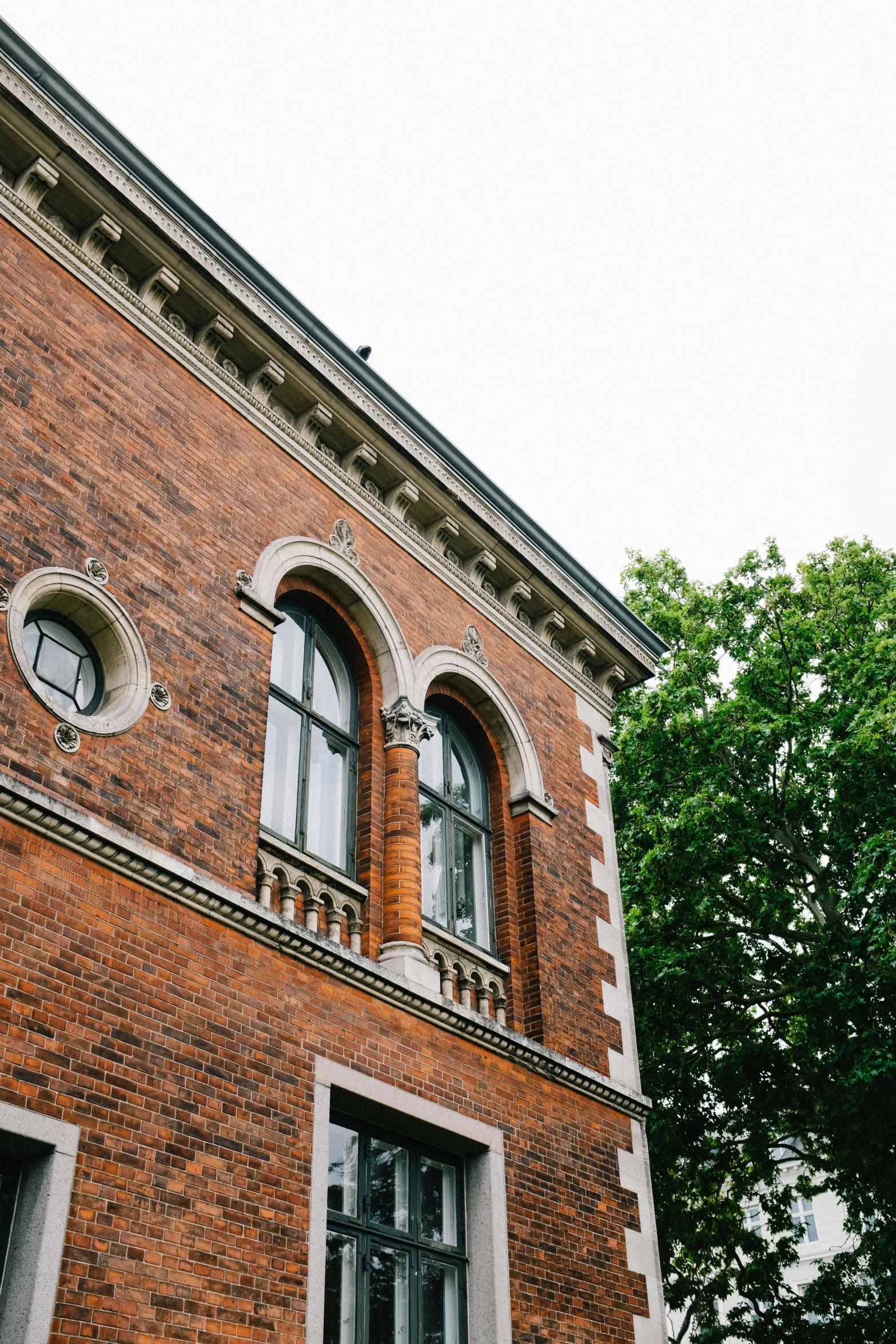 a brick building with windows and the roof of it