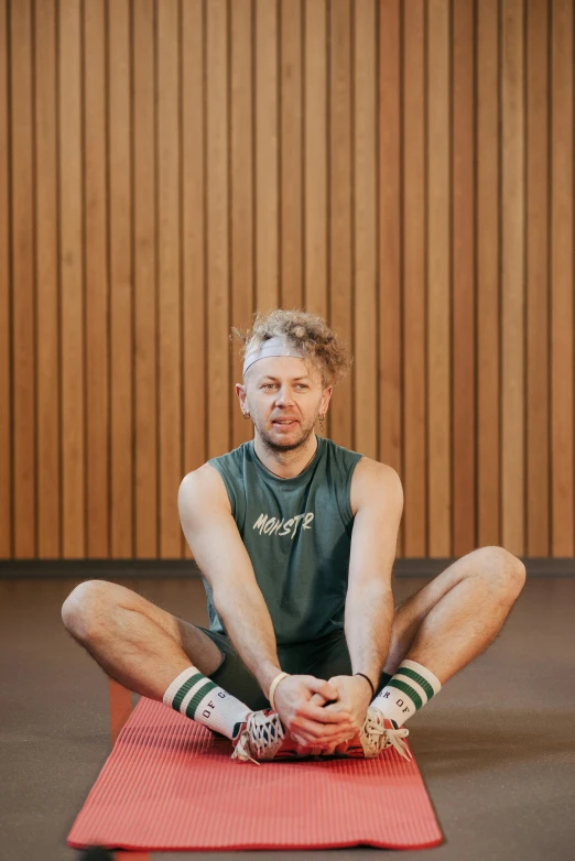 man doing a yoga pose on a mat