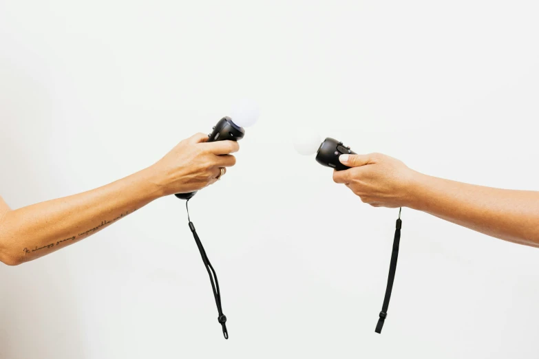 two men that are holding some sort of hairdryer