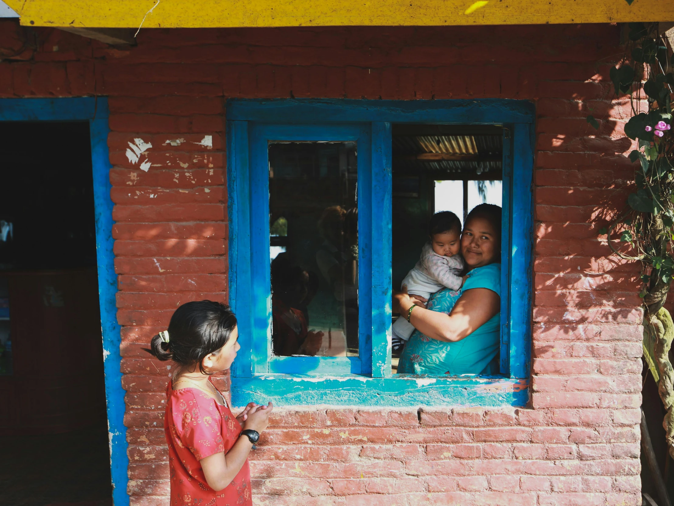 there is a baby being held by a woman