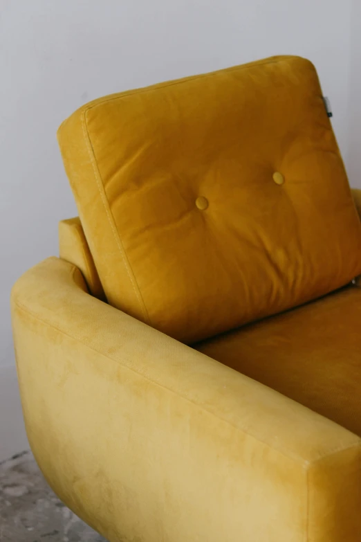 there is a yellow couch with pillows on it