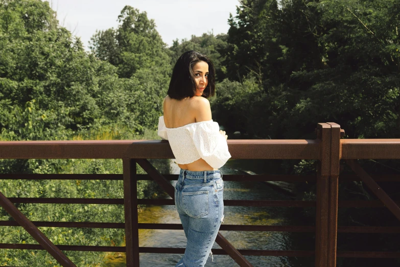 a woman leaning on a rail and posing for a po