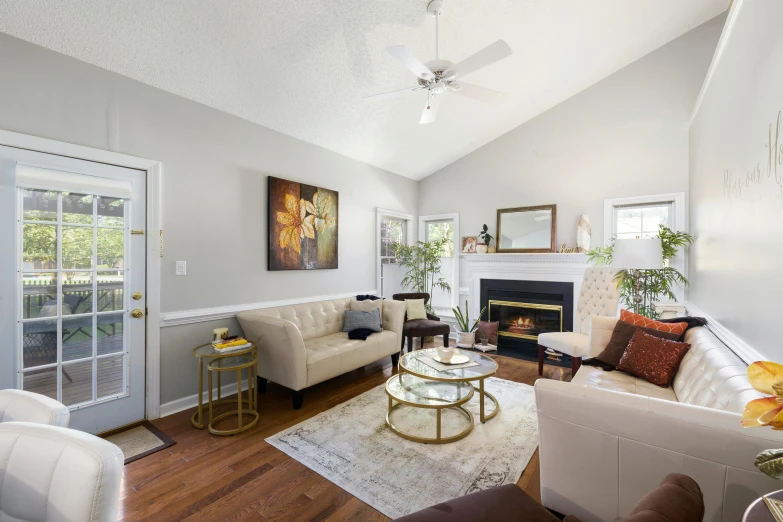 a room with a couch, coffee table and fireplace