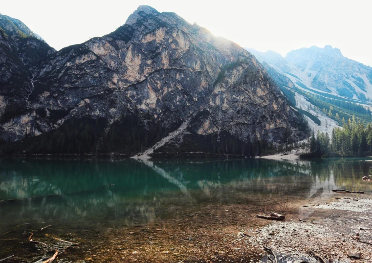 a mountain is reflected in the calm water