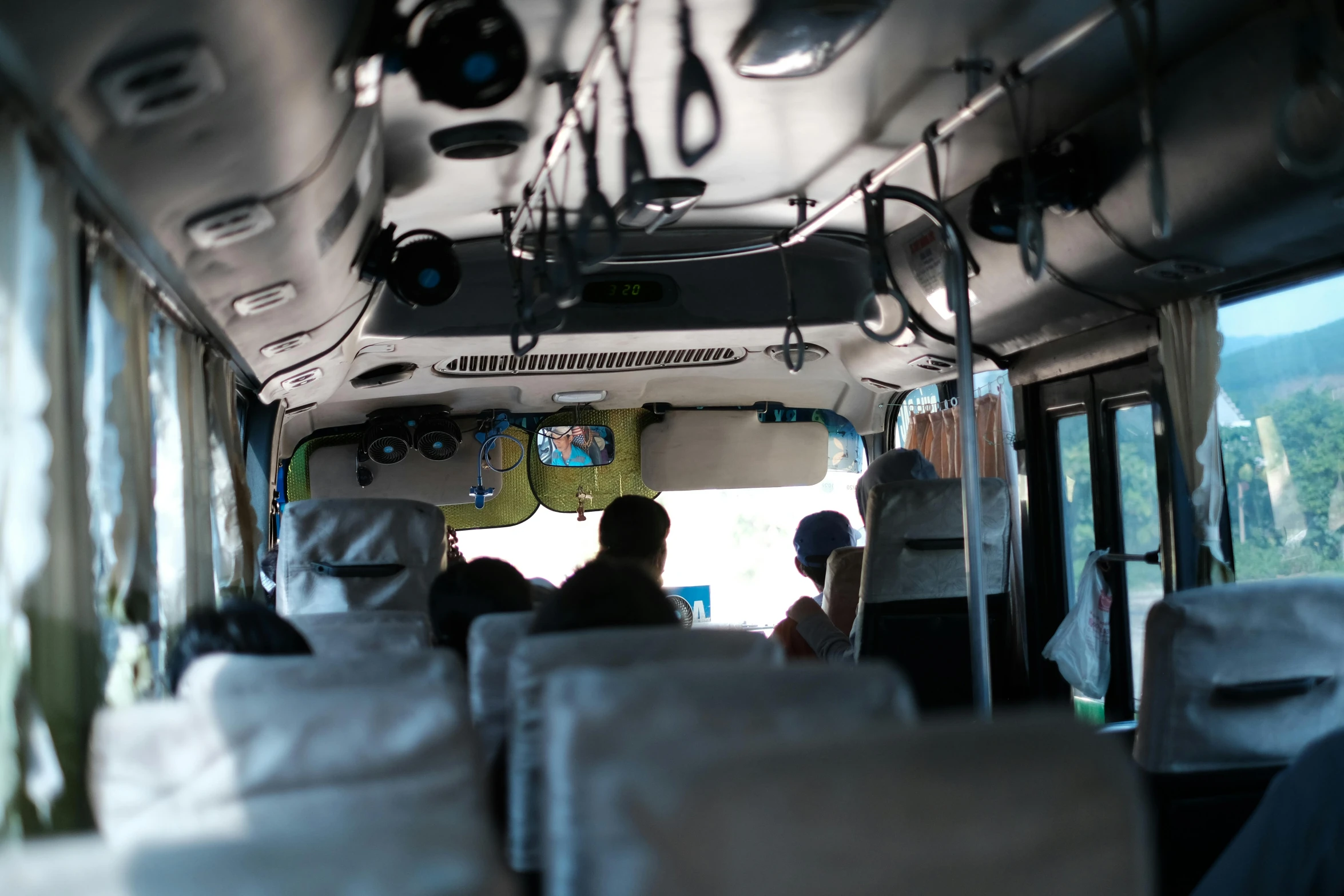 people on public transit bus with large windows