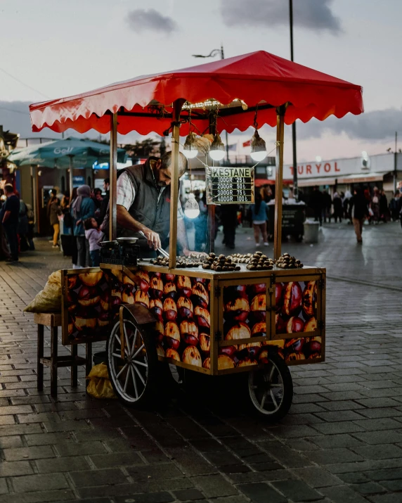 an ice cream cart selling treats in a busy outdoor square